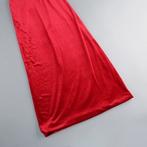Detailed close-up of premium red velvet fabric showing rich texture and elegant drapes