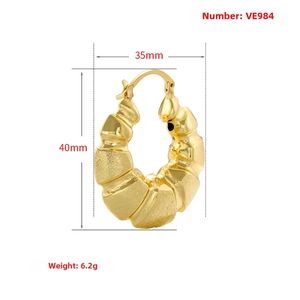 Detail view of 40mm hollow C-shaped gold hoop earrings with ribbed texture and dimensions