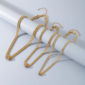 Detailed close-up of three gold twist rope knot necklaces in varying thicknesses on stands
