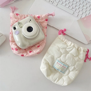 Detailed view of quilted drawstring camera pouches with heart pattern and soft padding