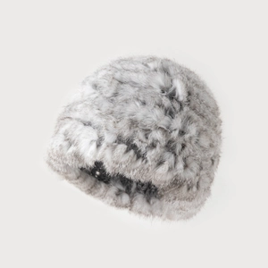 Close-up of thick faux rabbit fur texture on gray and white plush bucket hat