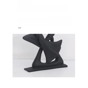 Close-up of black matte abstract sculpture detail showing minimalist craftsmanship and texture