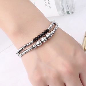 Waterproof stainless steel bead bracelet with black faceted crystal beads on model's wrist