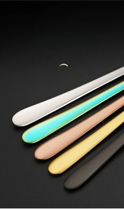 Close-up of five colorful stainless steel spoon handles with premium polished finish