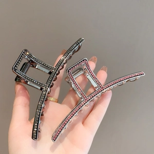Elegant large shark hair clip with sparkling black and pink rhinestones in luxury metal