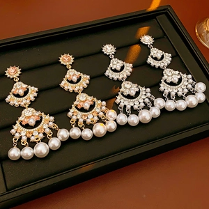 Detailed view of fan-shaped tassel earrings with crystal fringe and elegant pearls