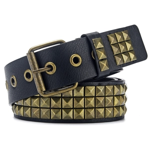 Detail of three-row pyramid metal studs on a black Y2K punk style leather belt