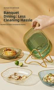 Close-up of hammer-textured glass plates with gold edges and metal display stand
