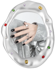 Detail showing an irregular silver mirror reflecting double-layered S925 rings with pearl