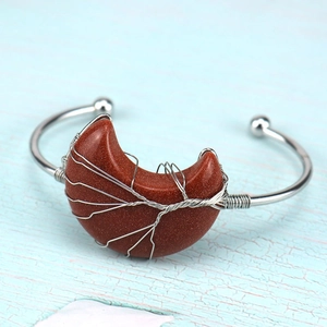 Detail of silver wire wrapped Tree of Life on moon-shaped brown sandstone bangle