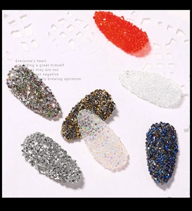 Macro detail of seven colorful 3D nail art micro-beads with sparkling crystal texture