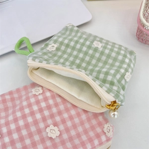 Detailed view of floral embroidery mesh pouch with an elegant pearl zipper puller