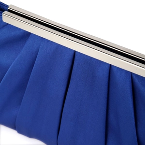 Close-up of elegant pleated dark blue satin evening clutch with silver metal frame