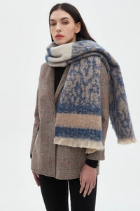 Close-up of leopard jacquard scarf with blue accents and soft fringe tassels