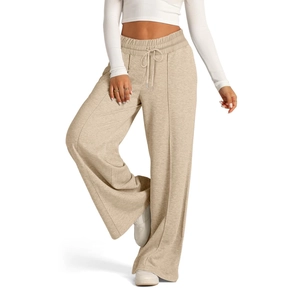 Detail of oatmeal knit wide-leg pants with elastic drawstring waist and seam piping