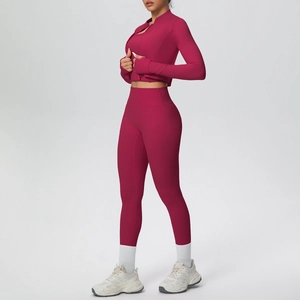 Detail of plum red yoga set showing thumbhole cuffs and ergonomic high-stretch fabric