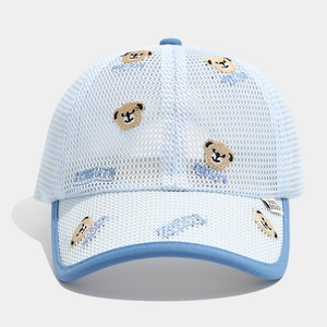 Detailed close-up of light blue mesh fabric with bear embroidery on a summer cap