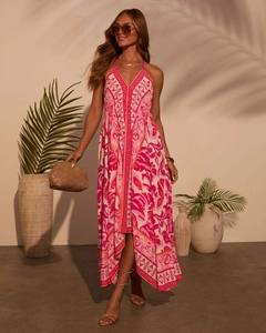 Detail of floral halter maxi dress featuring a deep V-neck and asymmetric hemline