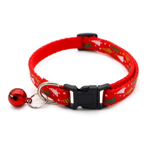 Close-up of red Christmas tree print pet collar with a festive red metal bell