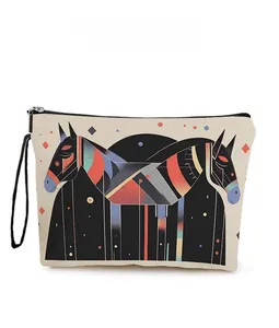 Detail of canvas toiletry bag with geometric horse pattern and black wrist strap