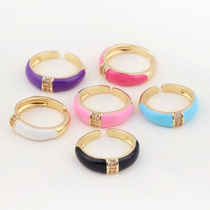 Detail of six colorful enamel rings with gold plating and sparkling micro diamonds