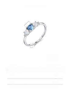 Detailed view of s925 silver ring with center blue gem and white opal stones