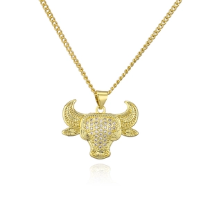 Detailed close-up of 18K gold plated bull head pendant with sparkling cubic zirconia