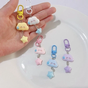 Macro detail of cute cloud and star keychains in pastel colors and resin material
