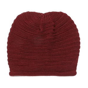 Close-up of deep red knitted beanie showing fine texture and thick weaving process