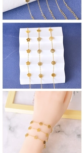 Detailed view of gold stainless steel bracelets featuring flower and tree of life charms