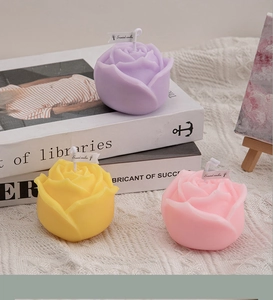 Detailed close-up of rose-shaped scented candles in purple, yellow, and pink colors