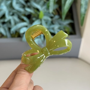 Olive green irregular bow-shaped resin hair claw clip with golden metal spring