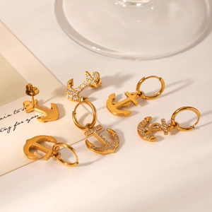 Detail of 18K gold stainless steel anchor earrings with white zircon stone accents