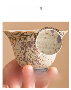 Macro detail of wisteria porcelain cup with caramel volcanic stone glaze and gold accents
