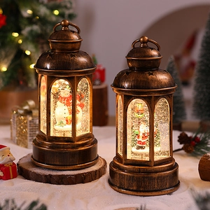 Detail of vintage bronze Christmas lantern with Santa, snowman and warm LED lighting
