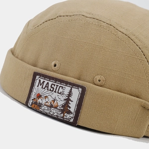 Khaki retro docker hat with outdoor style patch and canvas texture shown in side view