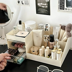 Detailed view of cream cosmetic storage box featuring clear drawers and multi-slot compartments