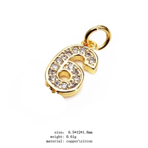 Macro view of a 14K gold-plated number 6 pendant with pavé zircon for jewelry making