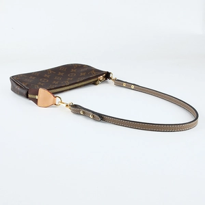 Detail view of brown lychee grain leather shoulder strap for basket bags with metal hooks