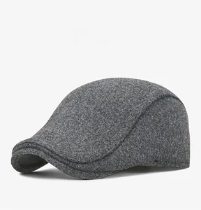 Detail view of winter dark grey wool blend flat cap with ear protection at a 45-degree angle
