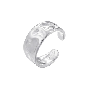 Detailed view of silver irregular hammered ear cuff with metallic glossy finish