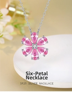 Macro view of S925 silver necklace featuring a six-petal flower pendant with pink zircons