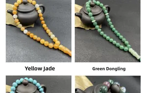 Macro shot of natural crystal prayer beads with a t-bead佛头 and traditional tassel detail