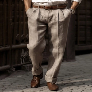 Detail of men's linen pants featuring vintage pleats, leather belt and rolled cuffs