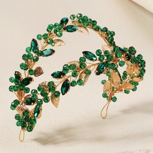 Handmade gold vine headband with green crystals and leaf accents for bridal styling