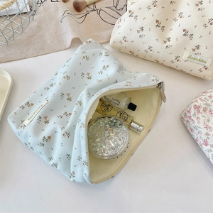Floral makeup bag interior view showing large capacity for cosmetics and perfume