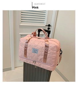 Pink quilted travel bag with shoe compartment shown mounted on silver suitcase handle