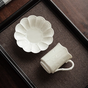 Exquisite white ceramic teacup and floral embossed saucer set with a bamboo-style handle