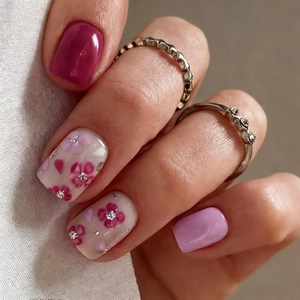 Short square press-on nails with deep rose pink and hand-painted floral art design