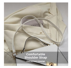 Detail of comfortable shoulder strap on white faux crocodile leather crossbody bag